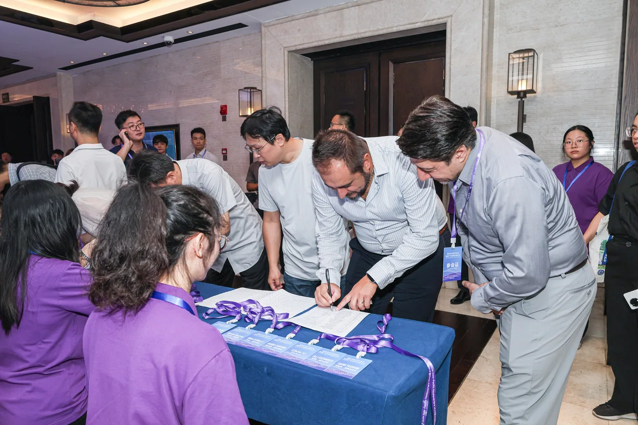 Conference guests and staff talking at the welcome desk