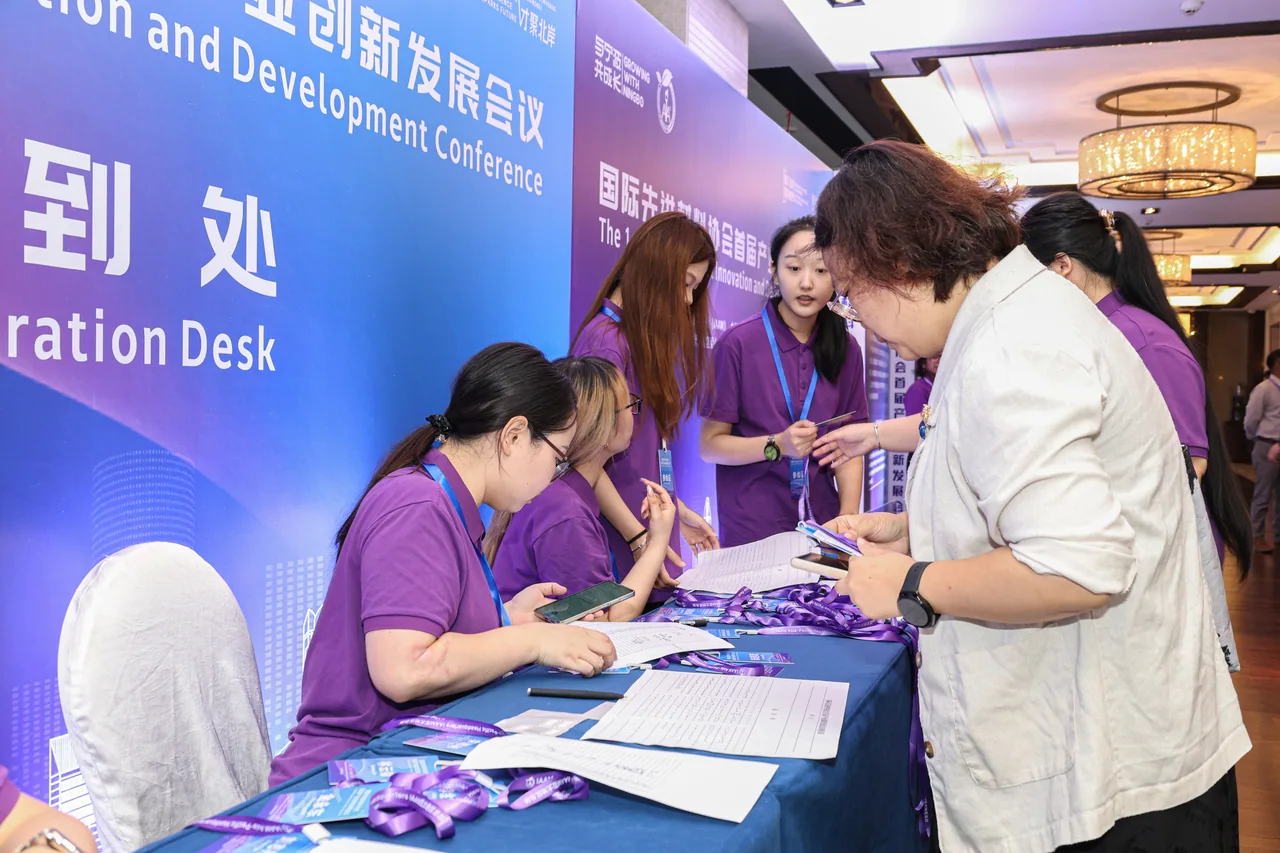 Conference visitors and staff at the registration desk