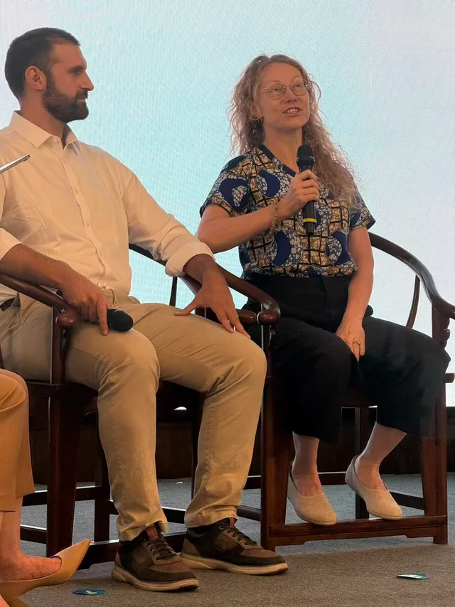 Two speakers discussing ideas on stage