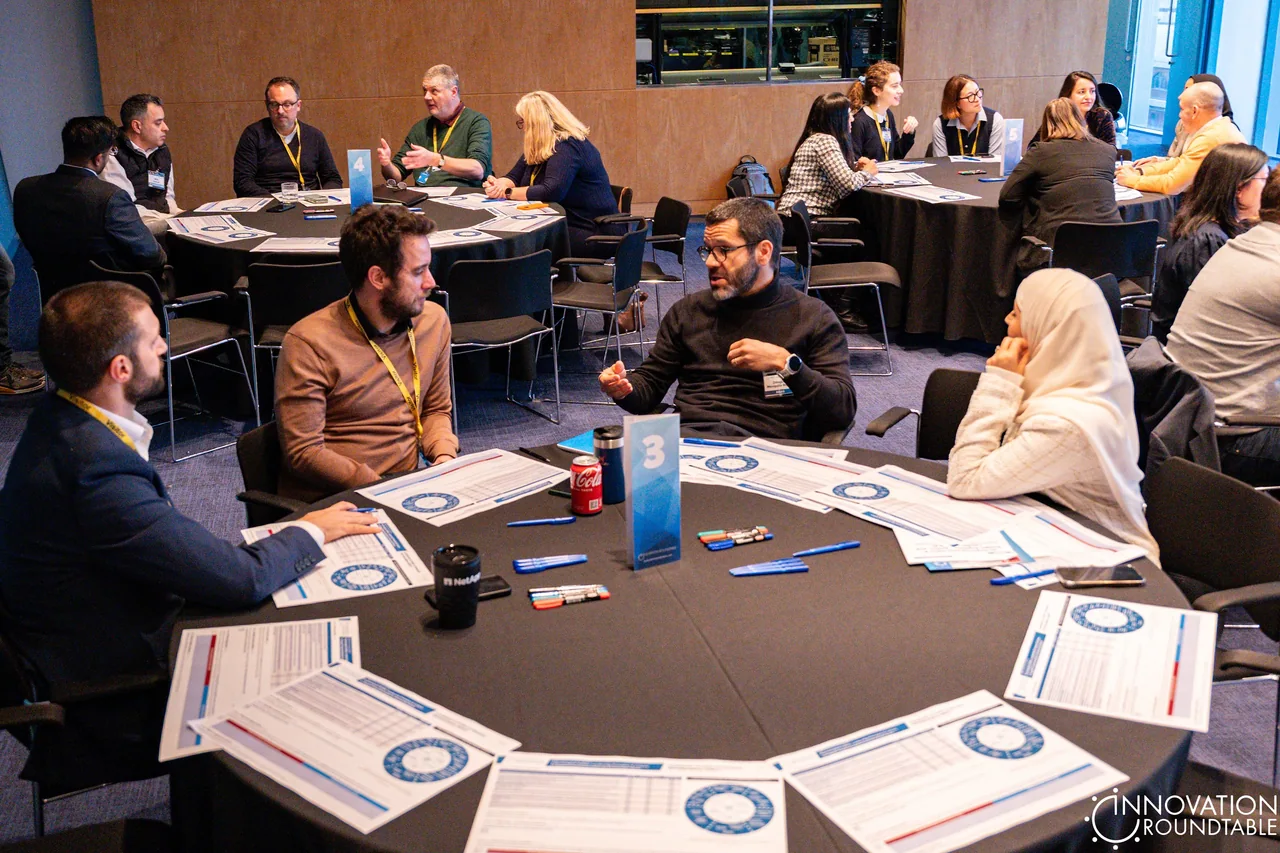 Participants sharing business ideas at a roundtable discussion